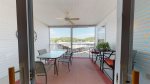 UPPER SCREENED IN BALCONY WITH LAKE VIEWS, TABLES AND CHAIRS